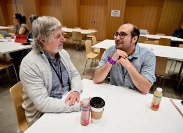 Two attendees having a conversation at a table