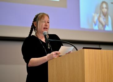 Melissa Fishman at the podium