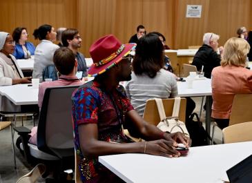 Attendees listening to and/or watching presenters