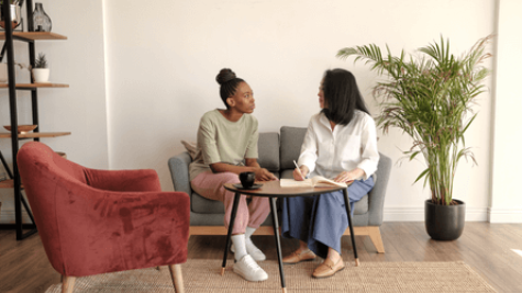 two women having a conversation at a table