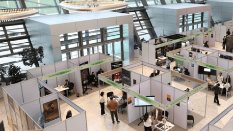 people networking and exploring booths at a career fair