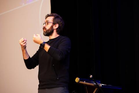 A sign language interpreter signs to the audience