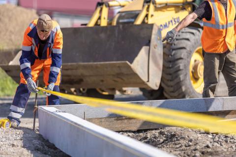 construction worker on site taking measurements