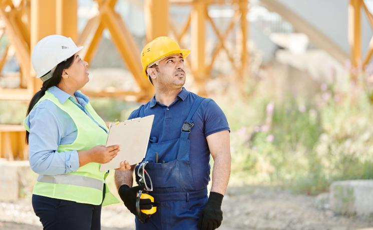 construction workers looking on a work site 
