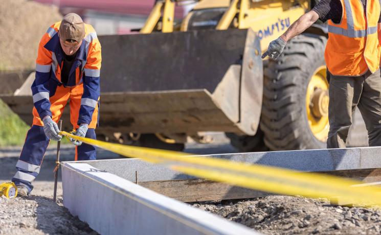 construction worker on site taking measurements