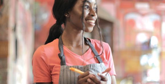 Woman taking an order at a café