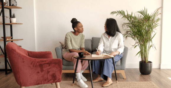 two women having a conversation at a table