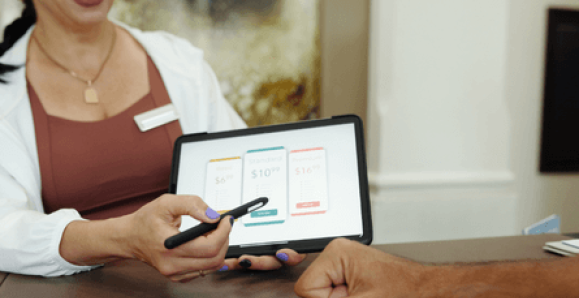 a woman presenting pricing options to a customer using their tablet