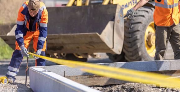 construction worker on site taking measurements